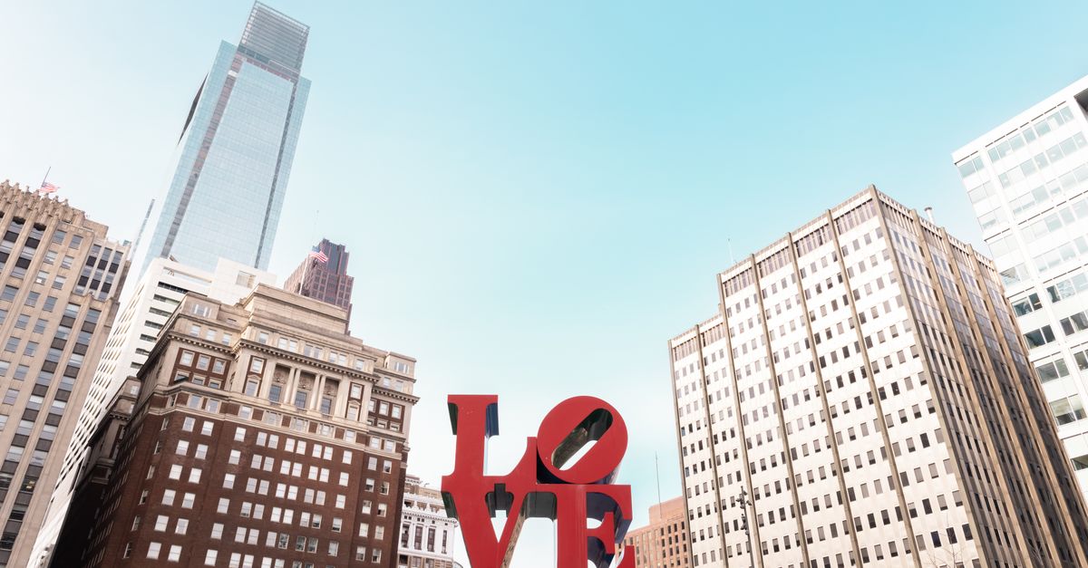 The iconic LOVE sculpture against Philadelphia's downtown skyline on a clear day.